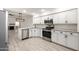 Updated kitchen featuring white shaker cabinets, granite countertops, and stainless steel appliances at 5711 N 24Th Pl, Phoenix, AZ 85016