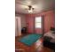 Comfortable bedroom with tile flooring, ceiling fan, and brightly colored walls at 5713 W Sun Dance Dr, Queen Creek, AZ 85144