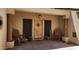 Inviting front entrance with rocking chairs, rustic decor, and a wooden door with a star emblem at 5713 W Sun Dance Dr, Queen Creek, AZ 85144