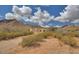 Desert home exterior showcasing stucco walls and mountain views at 5713 W Sun Dance Dr, San Tan Valley, AZ 85144