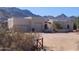 Inviting desert home with two-car garage, arched gated entrance, and mountain views at 5713 W Sun Dance Dr, Queen Creek, AZ 85144