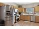 Kitchen boasts stainless steel appliances and light wood cabinets at 5713 W Sun Dance Dr, San Tan Valley, AZ 85144