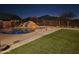 Inviting pool area with rock waterfall and fire pit features at 5713 W Sun Dance Dr, San Tan Valley, AZ 85144