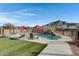 Relaxing pool area with artificial turf and mountain views at 5713 W Sun Dance Dr, San Tan Valley, AZ 85144