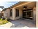 Covered patio with sliding glass door access, ceiling fan, and adjacent grassy area at 5810 W Puget Ave, Glendale, AZ 85302