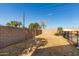 Large backyard with gravel landscaping and block wall at 5810 W Puget Ave, Glendale, AZ 85302