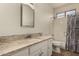 Bathroom with granite countertop, white vanity, and shower/tub at 5810 W Puget Ave, Glendale, AZ 85302