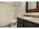 Bathroom with granite countertop, dark vanity, and bathtub at 5810 W Puget Ave, Glendale, AZ 85302