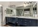 Updated bathroom with double vanity, marble countertop, and large mirror at 5810 W Puget Ave, Glendale, AZ 85302