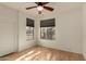 Bedroom with wood floors, ceiling fan, and large windows at 5810 W Puget Ave, Glendale, AZ 85302