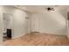 Bedroom with wood flooring, adjacent bathroom, and ceiling fan at 5810 W Puget Ave, Glendale, AZ 85302