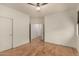 Bright bedroom with light wood flooring and ceiling fan at 5810 W Puget Ave, Glendale, AZ 85302