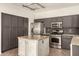 Modern kitchen with stainless steel appliances and granite island at 5810 W Puget Ave, Glendale, AZ 85302