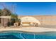 Relaxing backyard oasis with a firepit and kidney-shaped pool at 5810 W Puget Ave, Glendale, AZ 85302