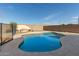 Inviting kidney-shaped pool with surrounding concrete decking at 5810 W Puget Ave, Glendale, AZ 85302