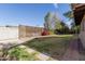 Backyard with grassy area, lattice fence and walkway at 6046 W Carol Ann Way, Glendale, AZ 85306