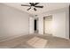 Bedroom with ceiling fan, sliding closet doors and neutral wall color at 6046 W Carol Ann Way, Glendale, AZ 85306