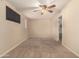 Bright bedroom featuring carpeted floors and ceiling fan at 6046 W Carol Ann Way, Glendale, AZ 85306