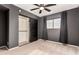 Bright bedroom with ceiling fan, mirrored closet doors, and neutral decor at 6046 W Carol Ann Way, Glendale, AZ 85306