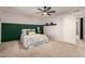 Bedroom with a queen-size bed and green accent wall at 6046 W Carol Ann Way, Glendale, AZ 85306