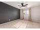 Bedroom with gray accent wall, ceiling fan and neutral carpet at 6046 W Carol Ann Way, Glendale, AZ 85306