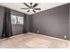 Spacious bedroom with ceiling fan, carpet, and neutral-colored walls at 6046 W Carol Ann Way, Glendale, AZ 85306