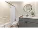 Clean bathroom with tub, toilet and gray vanity at 615 W Enid Ave, Mesa, AZ 85210