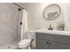 Modern bathroom with gray vanity, shower, and toilet at 615 W Enid Ave, Mesa, AZ 85210