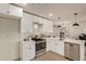 Modern kitchen with white cabinets and stainless steel appliances at 615 W Enid Ave, Mesa, AZ 85210