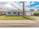 Charming single story home with red door and nicely landscaped lawn at 7443 E Taylor St, Scottsdale, AZ 85257