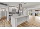 Modern kitchen with white cabinets, a large island, and stainless steel appliances at 7443 E Taylor St, Scottsdale, AZ 85257