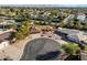 Aerial view of single story home with circular driveway, pool, and mountain views at 7550 E Ironwood Ct, Scottsdale, AZ 85258