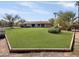 Large grassy backyard with mature trees and a spacious lawn at 7550 E Ironwood Ct, Scottsdale, AZ 85258