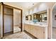 Bathroom boasts double vanity, large mirror, and built-in storage at 7550 E Ironwood Ct, Scottsdale, AZ 85258