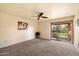 Bright bedroom with carpet flooring and sliding glass door to patio at 7550 E Ironwood Ct, Scottsdale, AZ 85258