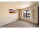 Spacious bedroom with carpet flooring and window with shutters at 7550 E Ironwood Ct, Scottsdale, AZ 85258