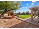 Brick firepit in the backyard with grassy area at 7550 E Ironwood Ct, Scottsdale, AZ 85258