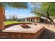 Circular brick firepit with sitting area in the backyard at 7550 E Ironwood Ct, Scottsdale, AZ 85258