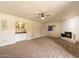 Gathering room with a fireplace, built-in wet bar, and carpet at 7550 E Ironwood Ct, Scottsdale, AZ 85258