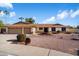 Single-story home with a two-car garage and well-maintained landscaping at 7550 E Ironwood Ct, Scottsdale, AZ 85258