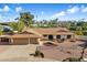 Single story home with two car garage and desert landscaping at 7550 E Ironwood Ct, Scottsdale, AZ 85258