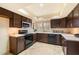 Kitchen with dark wood cabinets, stainless steel appliances at 7550 E Ironwood Ct, Scottsdale, AZ 85258