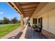 Covered patio with brick flooring and backyard access at 7550 E Ironwood Ct, Scottsdale, AZ 85258