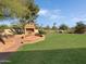 Brick patio with a built-in fireplace and fire pit at 7550 E Ironwood Ct, Scottsdale, AZ 85258