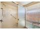 Clean shower with built-in seat and grab bar at 7550 E Ironwood Ct, Scottsdale, AZ 85258