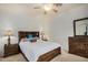 Bedroom with wood platform bed, ceiling fan, and wood nightstands at 7606 E Globemallow Ln, Gold Canyon, AZ 85118