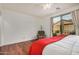 Bedroom with hardwood floors, sliding glass door, and ceiling fan at 7606 E Globemallow Ln, Gold Canyon, AZ 85118