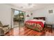 Bedroom with hardwood floors, sliding glass doors to backyard, and ceiling fan at 7606 E Globemallow Ln, Gold Canyon, AZ 85118