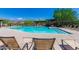 Community pool with lounge chairs and mountain views at 7606 E Globemallow Ln, Gold Canyon, AZ 85118