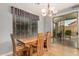 Dining area with wooden table and access to the backyard at 7606 E Globemallow Ln, Gold Canyon, AZ 85118